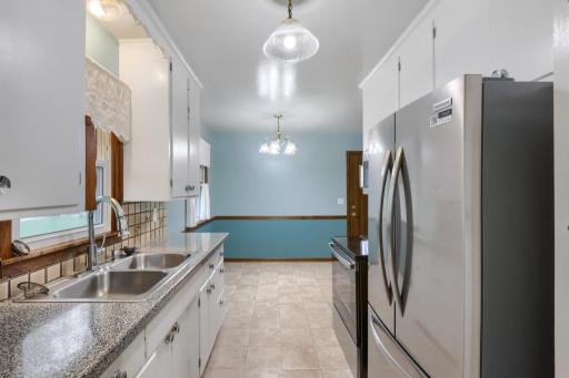 Walk thru kitchen. Updated flooring and counters. Stainless Steel Refrigerator, Electric Range and Built-in Microwave to stay. Brand NEW in 2025.