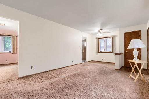 Formal living room with front entry closet. Hardwood floors under the carpet. Condition unknown.