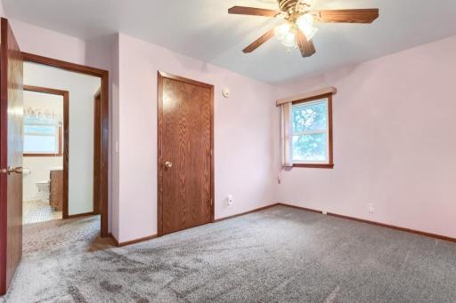 Bedroom #1 - Main floor with ceiling fan, hardwood floors under the carpet. Views of the backyard.