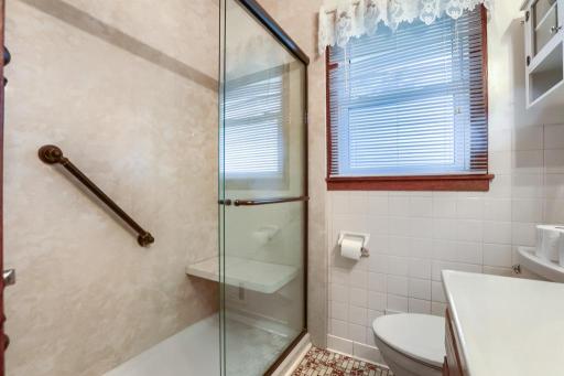 Bath updated with walkin Shower with Grab Bars and Bench.
