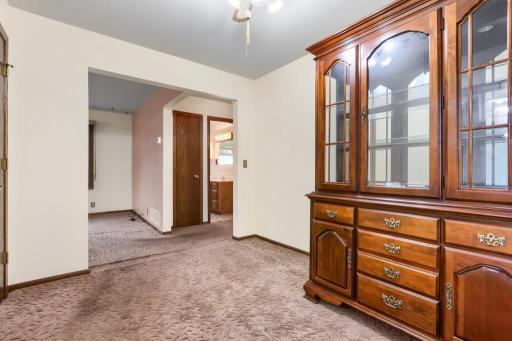 Walk thru formal dining room with a bay window, closet and hardwood floors under the carpet. Could also be used as a home office space.
