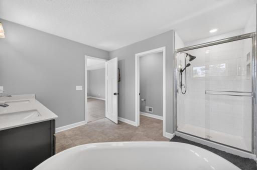 Primary bedroom soaking tub, double vanity and separate shower