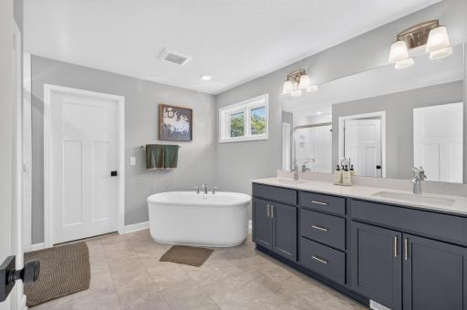 Primary bedroom soaking tub, double vanity and separate shower