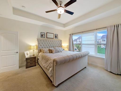 This luxurious primary bedroom is the perfect place to relax!