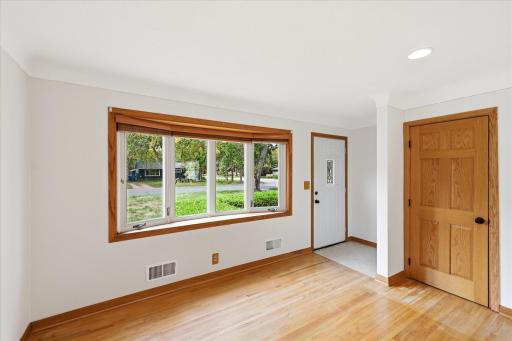 Light pours into the living room to brighten each day with shades available for privacy