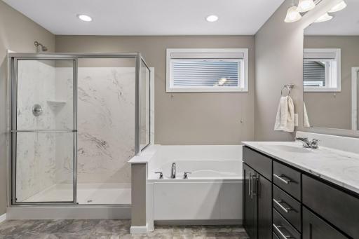 Primary bath features separate tub and shower