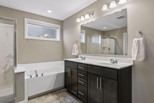 Primary bath with double sink vanity and separate tub and shower