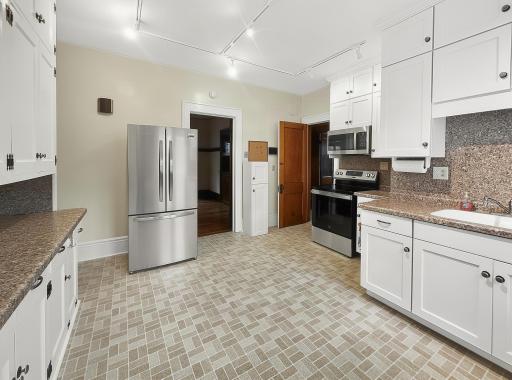 Large Kitchen with New Appliances, cabinets, countertops and sink. Plus room for a center Island.jpg