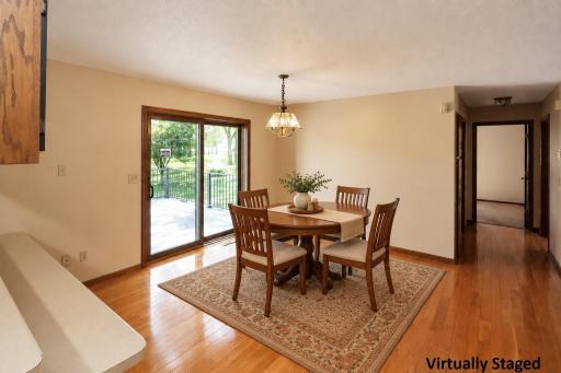 Spacious dining area with a patio door leading to the backyard deck (staged).jpg