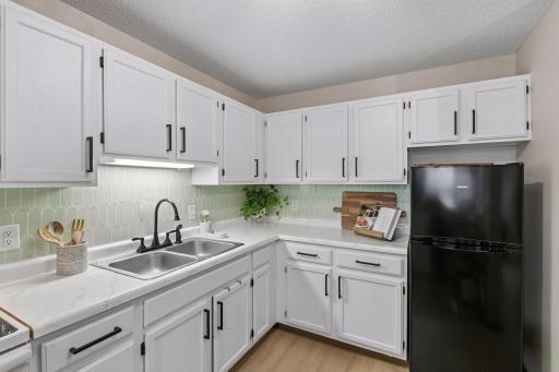 Kitchen flooring, cabinets and countertops were updated in 2023. The refrigerator is only two years old.