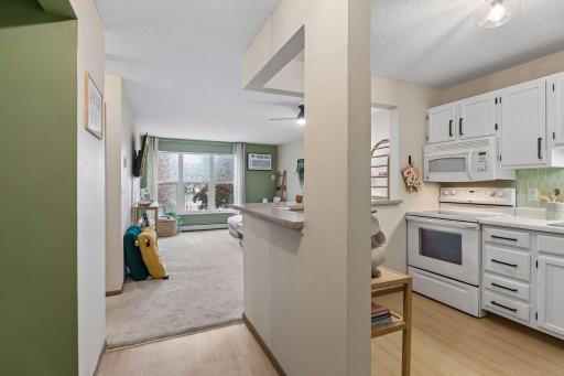 As you enter #120, the kitchen is off to your right.