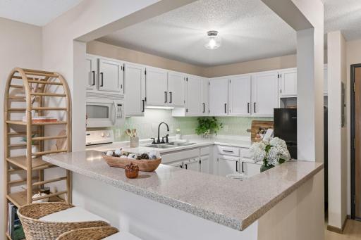 Your open kitchen with breakfast bar seating.