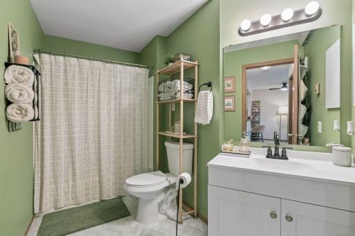 The freshly painted full-bath. The tub was reglazed and new fixtures were installed in 2023.