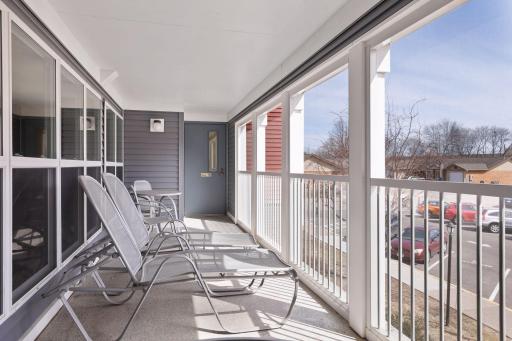 The screened-in porch with plenty of space to lounge.