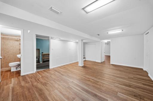 Freshly painted walls and new luxury vinyl plank flooring give the lower level family room a bright, updated feel. The spacious layout offers plenty of room to relax or entertain, with a 4th bedroom just steps away for guests or every day flexibility