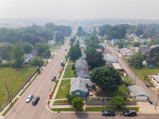 The street stretches out in both directions from above, framed by mature trees and easy access to main roads. Convenience and calm, side by side.