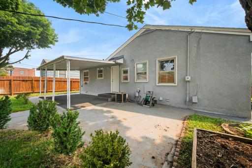 The back of the home opens to patio and yard on every side, with a privacy fence keeping it all your own.