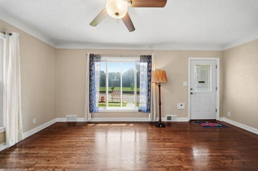 Light pours through the windows and pools on the original hardwood, floors that have carried decades of quiet mornings and Sunday afternoons. The whole family finds their own corner to land in. Evenings here slow all the way down.
