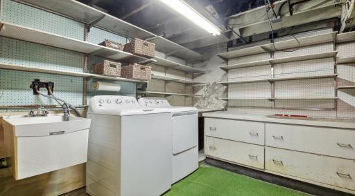 Lower level laundry includes a laundry sink and tons of storage space for all your goodies.