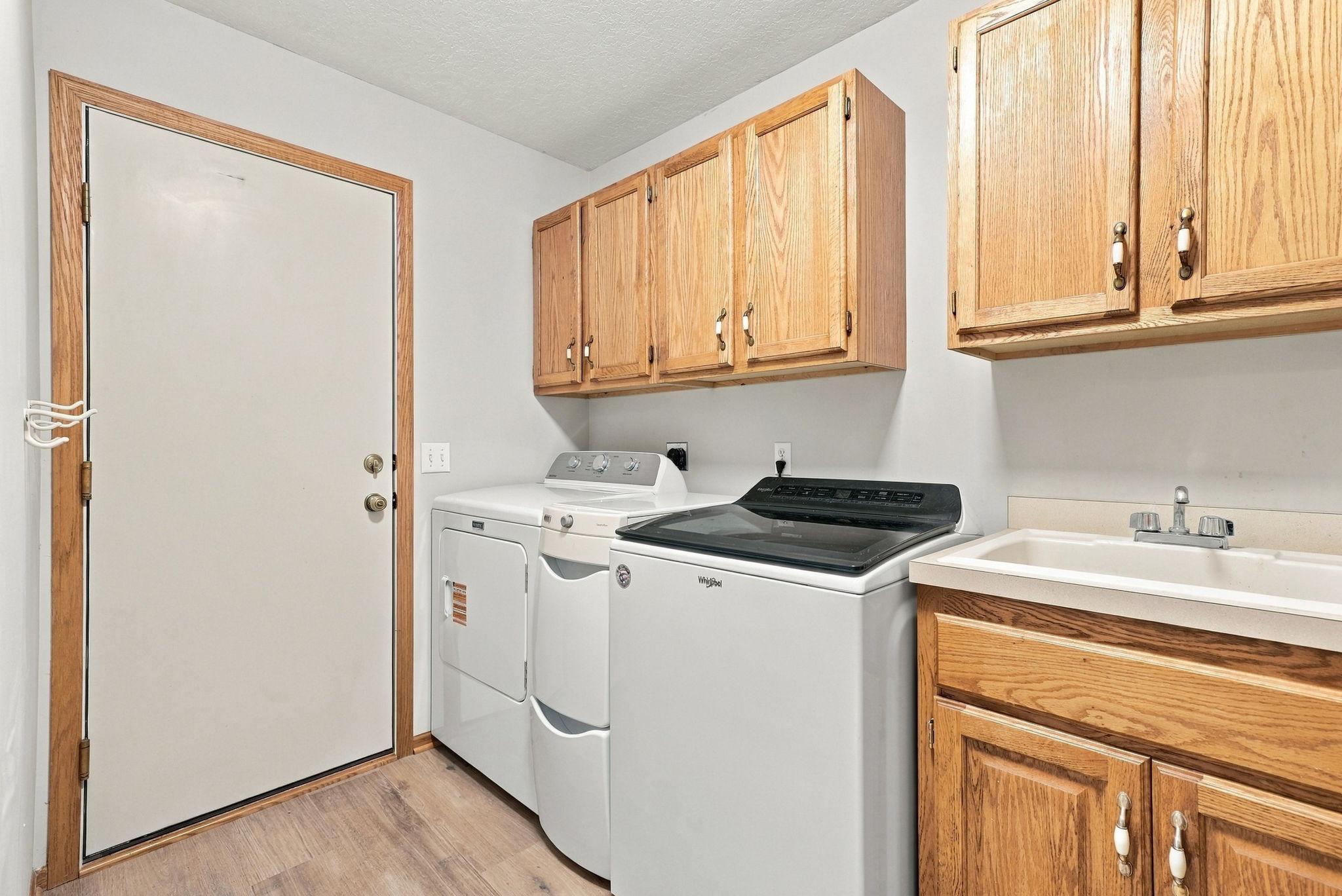 Washer, dryer, and sink in the laundry room.