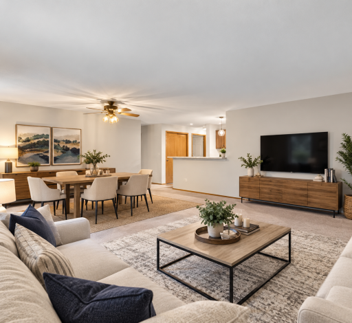 Virtually staged to highlight the generous living space and easy connection between the living, dining and kitchen areas.
