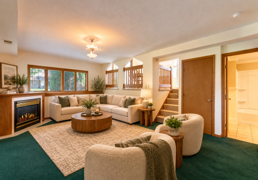 Lower Level family room with gas fireplace and tons of natural light! Virtually staged.