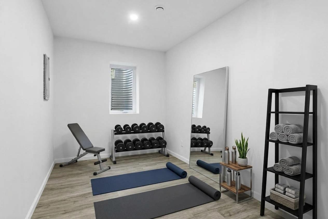 Lower level flex space. By adding a closet, it would be the 4th bedroom. Virtually staged.