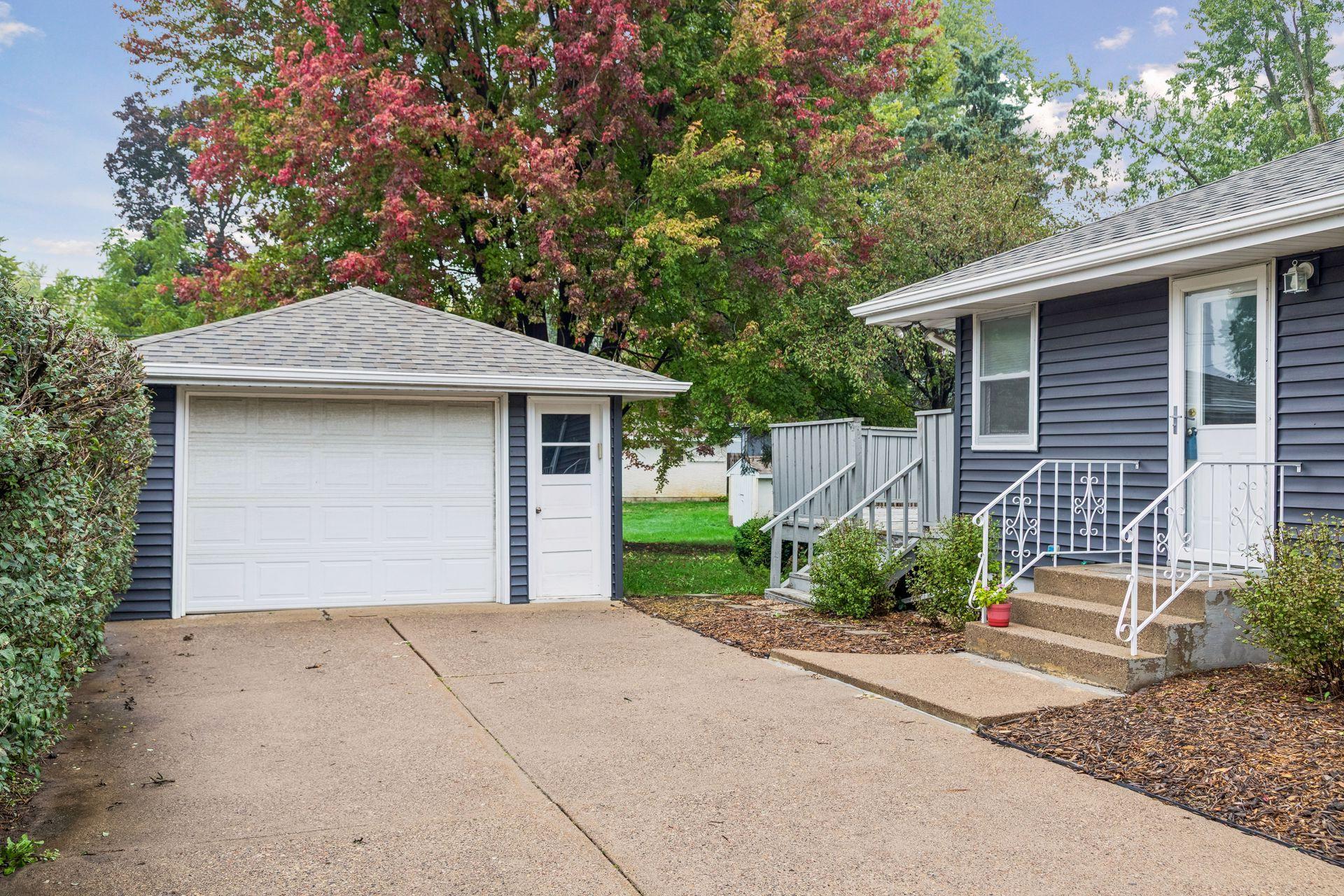 Detached garage and concrete driveway.