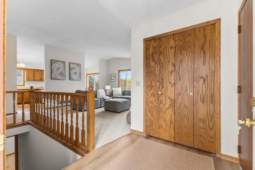 The front foyer has a large entry way with a large coat closet. The door to the oversized 2-car garage is to the right of this photo.