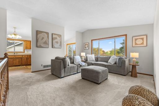 Upper level living room. This space and the dining space overlook the large back deck and yard.