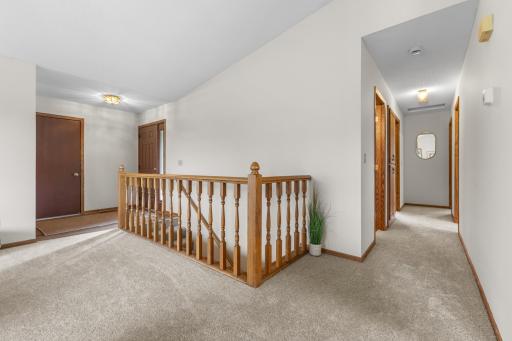 3 bedrooms and 2 bathrooms with a large hallway linen closet are down this hallway.