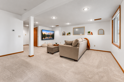 This lower level is outstanding. Walkout to a large backyard with wildflowers and gardens. The closet doors in this photos take you to the laundry room.