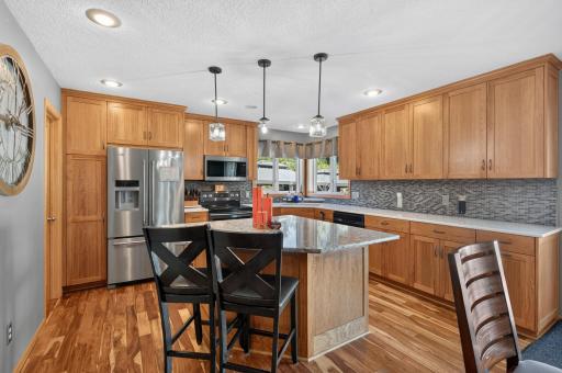 Granite countertops, tile backsplash, acacia wood cabinets & floors
