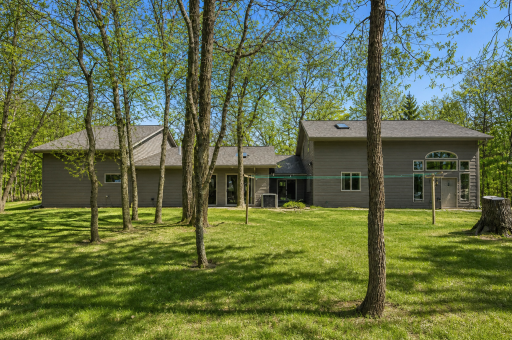 Back side of home (AI used to make yard/ trees green)