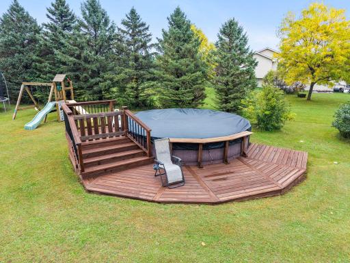 Above ground swimming pool with sand filter and deck