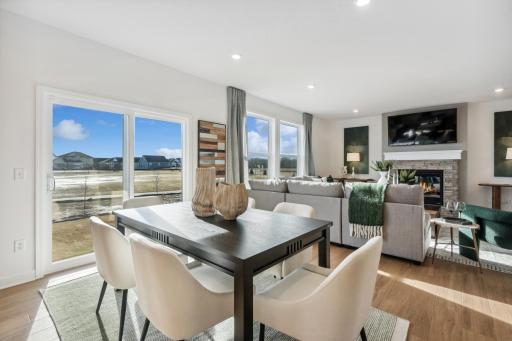 (Photo of decorated model, actual home's finishes will vary) Soaked in natural sunlight, the homes eat-in dining room has ample space for a dining table located in the heart of the home.