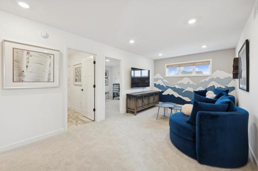 (Photo of decorated model, actual home's finishes will vary) Located on the upper level, this perfectly sized living space has enough room for a desk, television, and seating for all.