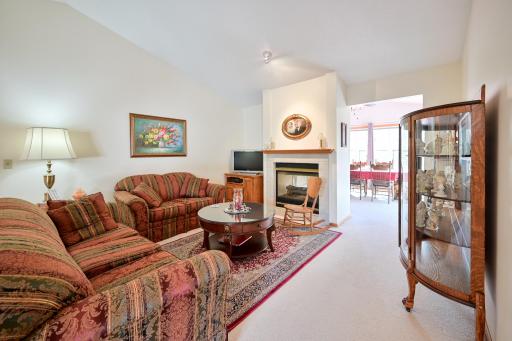Main floor living room with cozy gas fireplace.