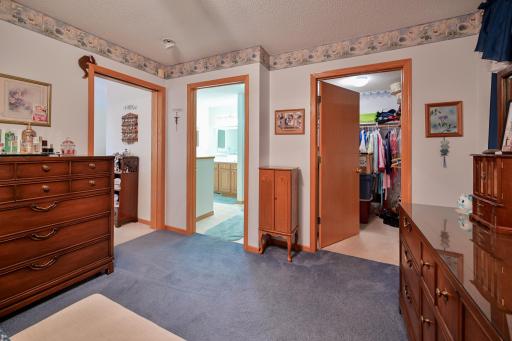 Primary bedroom with views of private bathroom and walk-in closet.