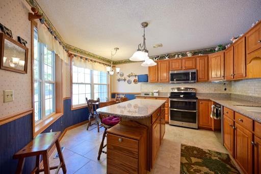 Light-filled kitchen with dinning nook and double ovens.