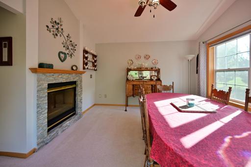 Another view of the sunroom/dining room with the two-sided fireplace.