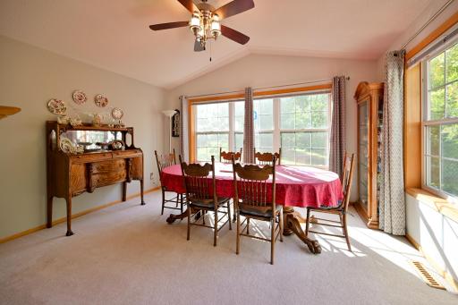 An abundance of light creates an inviting space in this sunroom, currently being used as a formal dining room.