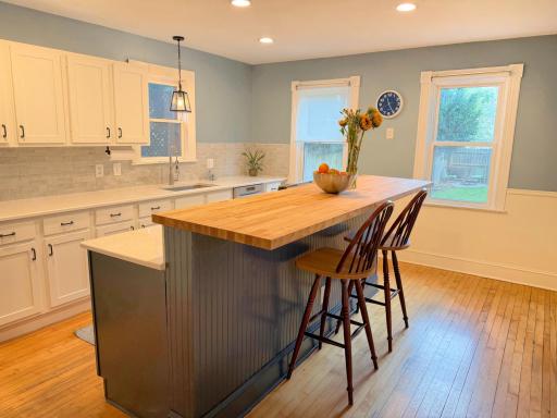 Beautifully renovated 2023 kitchen featuring expanded cabinetry, updated appliances, and a spacious center island.