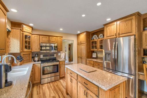 Spacious kitchen offering abundant cabinetry, center island, stainless steel appliances, and generous counter space.