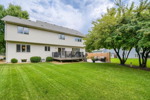 Enjoy multiple outdoor living spaces with a deck leading to the beautifully landscaped paver patio.