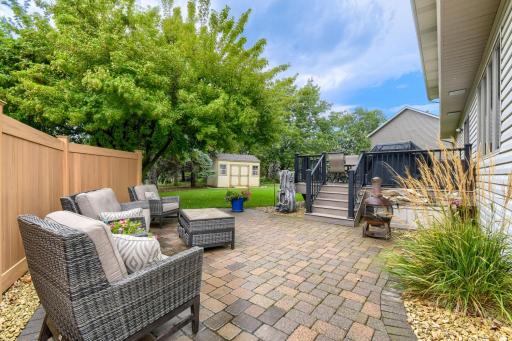 Patio area off of deck with privacy fence