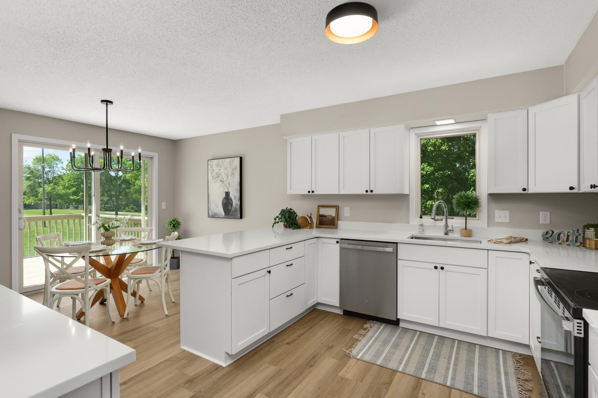 Updated Kitchen with new countertops, appliances, cabinets, flooring and lighting