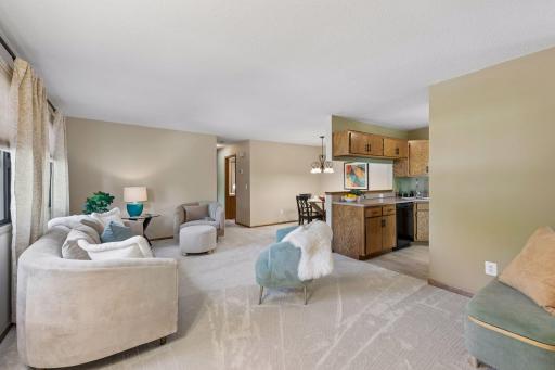 Fresh paint and new LifeProof stain-resistant carpet welcome you into a comfortable living room, with the dining area and kitchen close by for easy everyday living.