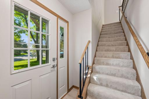 A bright entry and newly carpeted staircase lead up a full flight to the living room, kitchen, both bedrooms and bathroomâall together on the upper level.