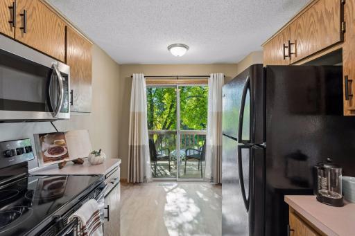Morning coffee is just steps awayâsliding doors lead from the kitchen to the brand-new deck, where mature trees create a cozy setting with welcome privacy.